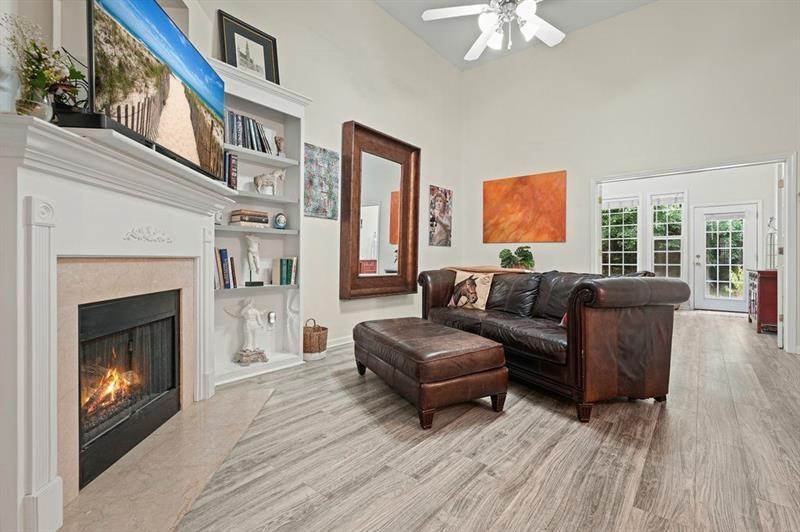 2521 Eden Ridge Lane, Unit 7 Acworth, GA 30101 - Photo 26 of 47 a living room with furniture a fireplace and a flat screen tv