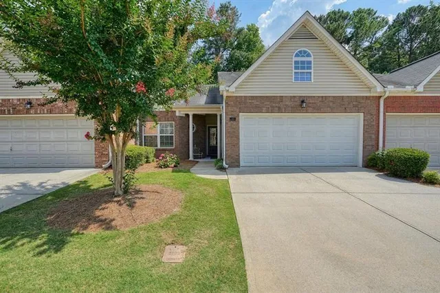 a front view of a house with garden