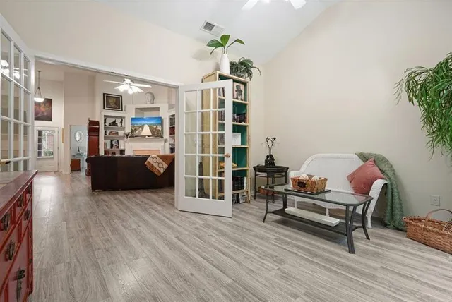 a living room with furniture and a wooden floor
