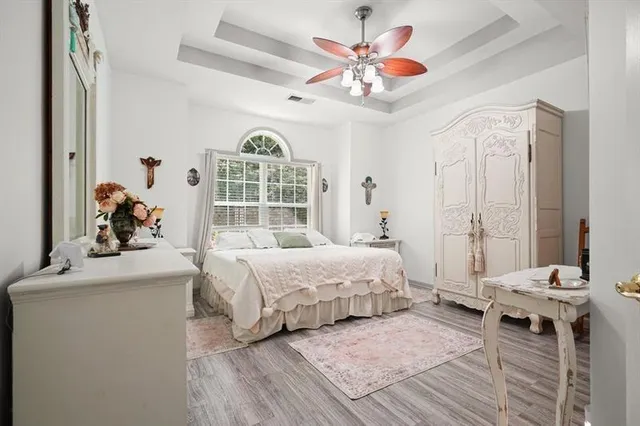 a bedroom with a bed and a chandelier