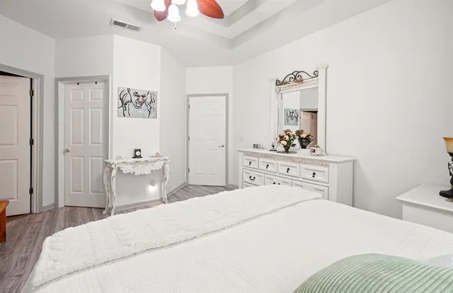 a bedroom with a bed and a chandelier