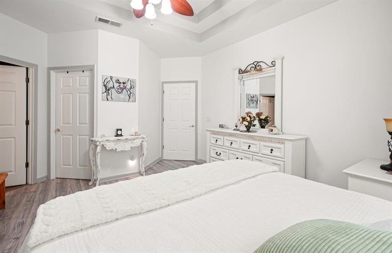 2521 Eden Ridge Lane, Unit 7 Acworth, GA 30101 - Photo 34 of 47 a bedroom with a bed and a chandelier