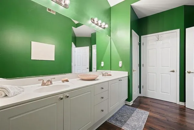 a bathroom with a double vanity sink and mirror