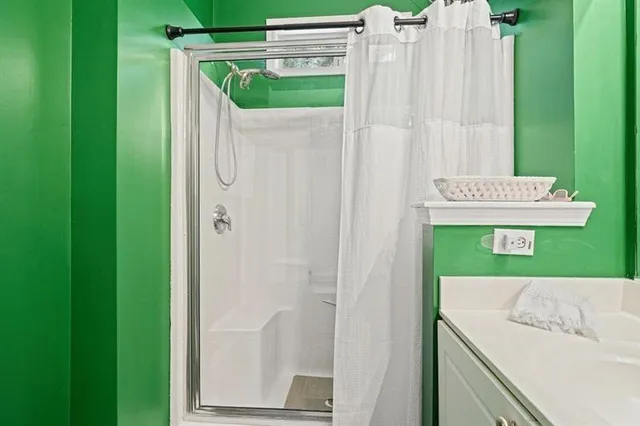 a bathroom with a shower and a sink