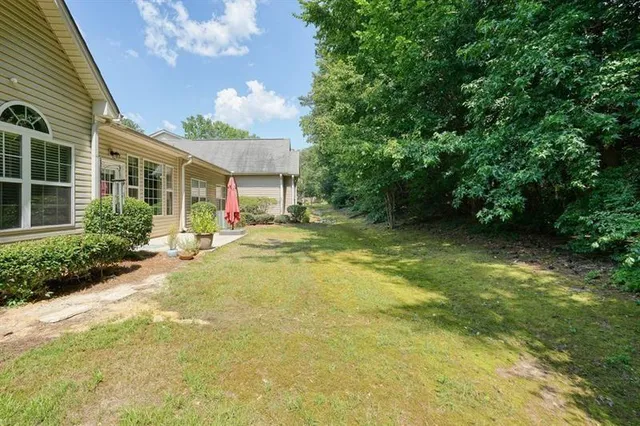 a view of a house with a large tree and plants