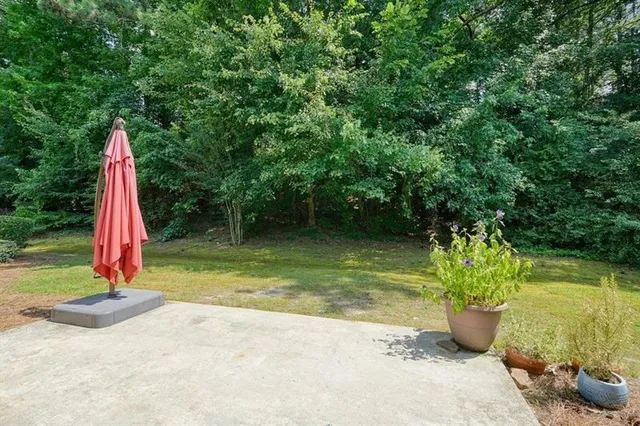a view of a lake with a small yard and potted plants