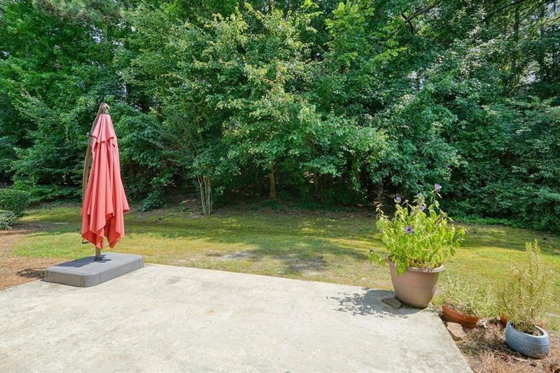 2521 Eden Ridge Lane, Unit 7 Acworth, GA 30101 - Photo 47 of 47 a view of a lake with a small yard and potted plants