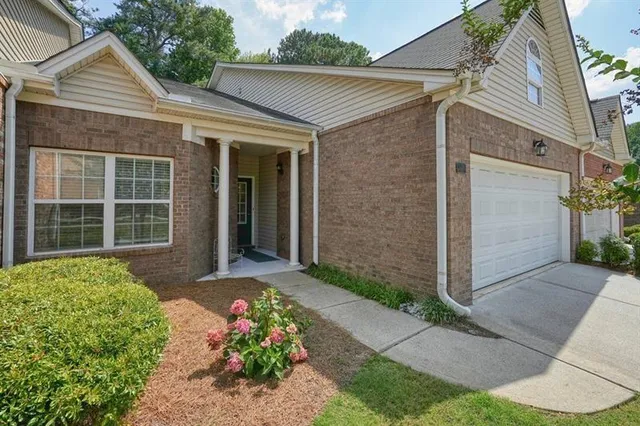 a front view of a house with a garden