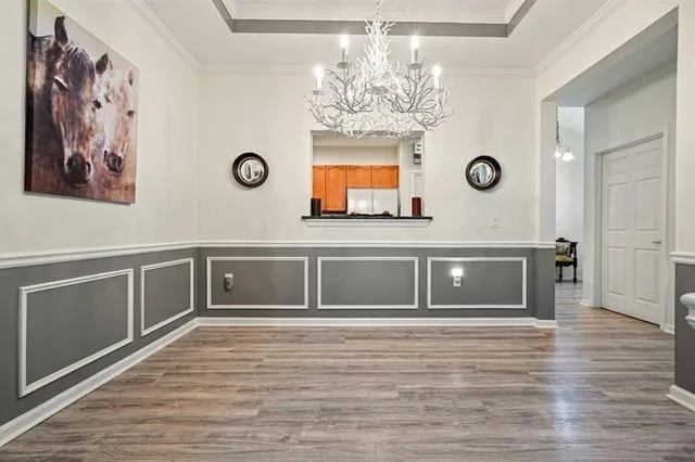 a view of a hallway with front door and wooden floor