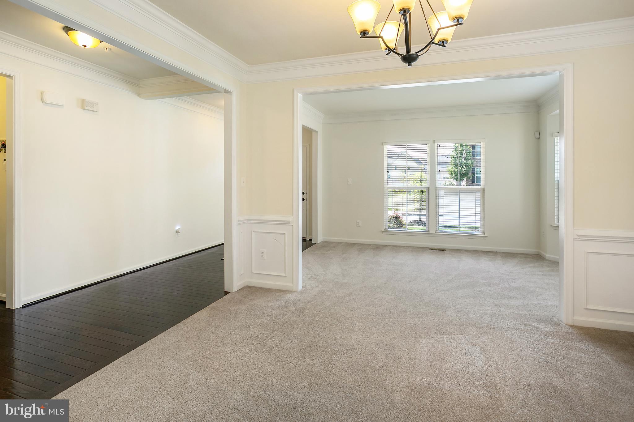 10576 Long Leaf Lane Waldorf, MD 20603 - Photo 11 of 54 an empty room with windows and chandelier
