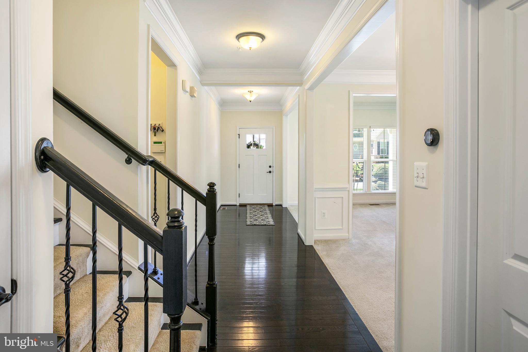 10576 Long Leaf Lane Waldorf, MD 20603 - Photo 12 of 54 a view of a hallway with wooden floor and staircase