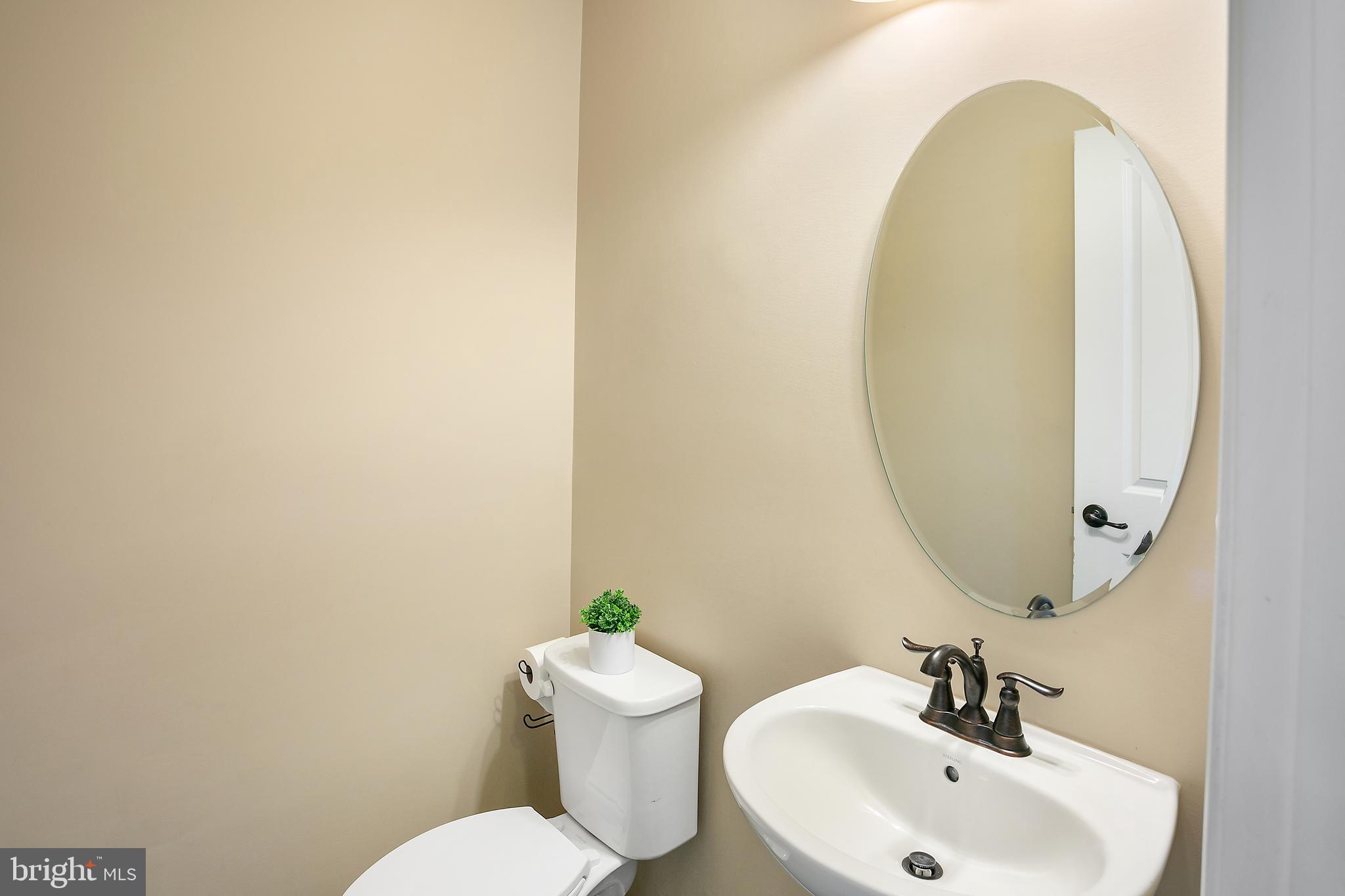 10576 Long Leaf Lane Waldorf, MD 20603 - Photo 13 of 54 a bathroom with a sink and a mirror