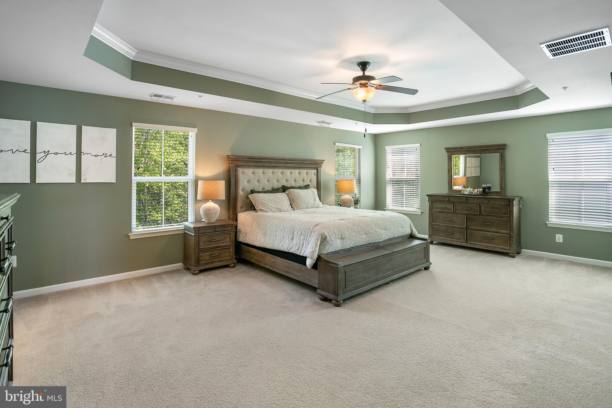 10576 Long Leaf Lane Waldorf, MD 20603 - Photo 15 of 54 a bedroom with a bed and a chandelier