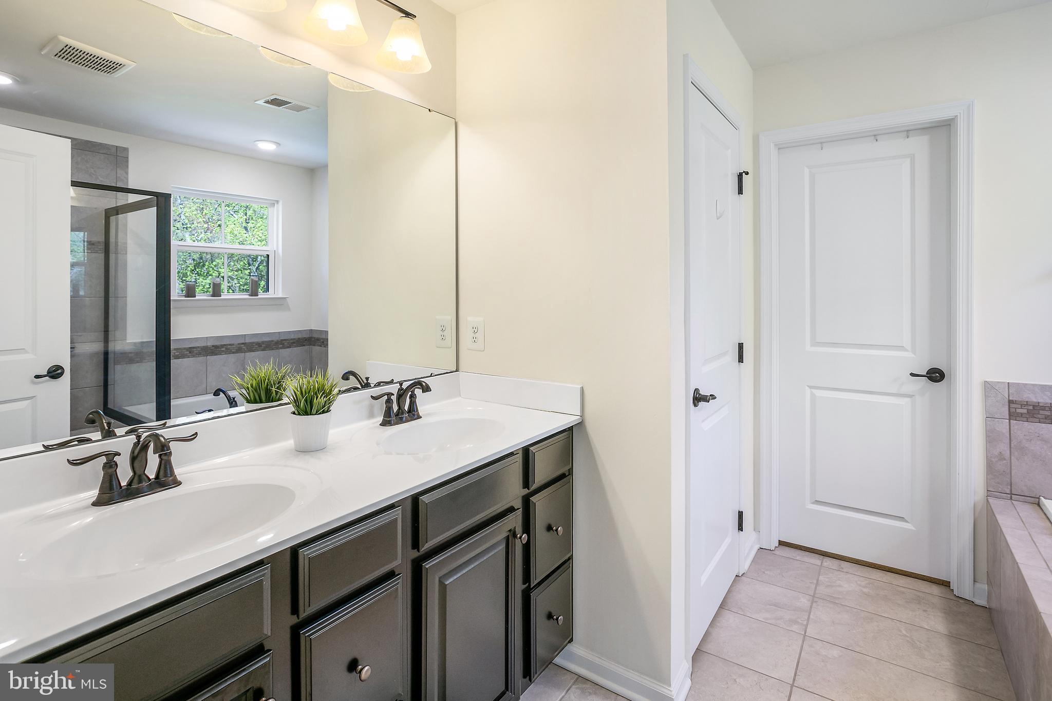 10576 Long Leaf Lane Waldorf, MD 20603 - Photo 19 of 54 a bathroom with a sink and a mirror