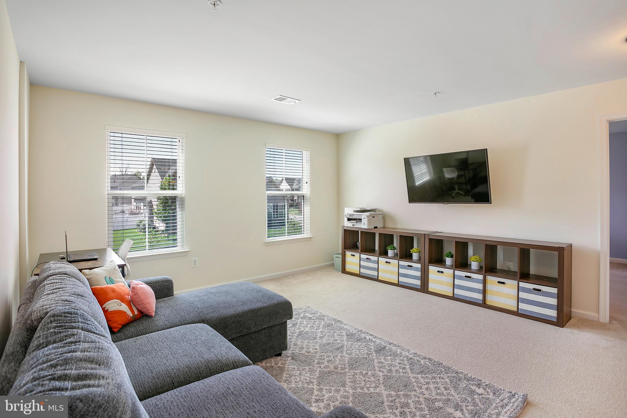 10576 Long Leaf Lane Waldorf, MD 20603 - Photo 26 of 54 a living room with furniture and a flat screen tv