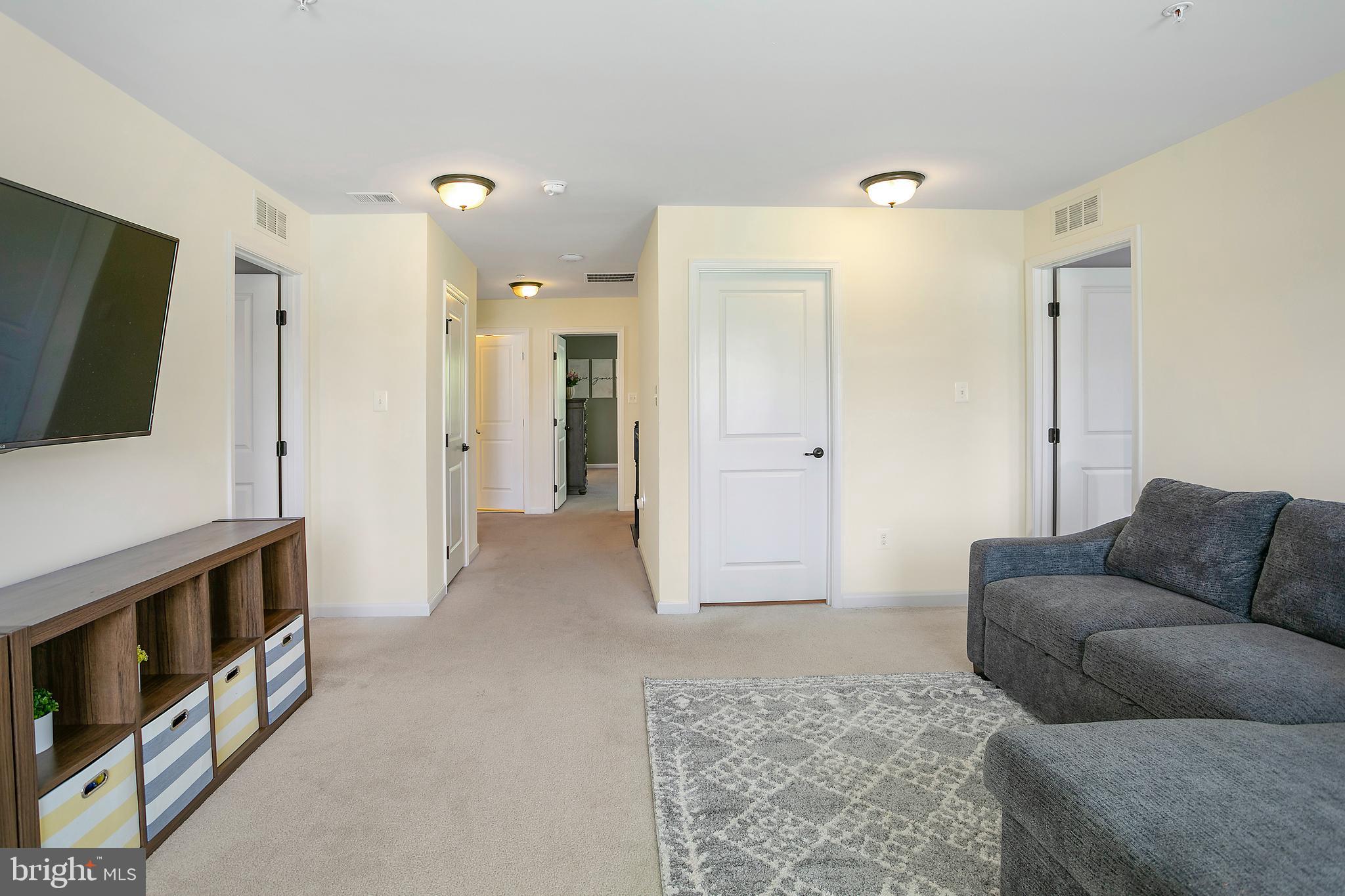 10576 Long Leaf Lane Waldorf, MD 20603 - Photo 27 of 54 a living room with furniture and a flat screen tv