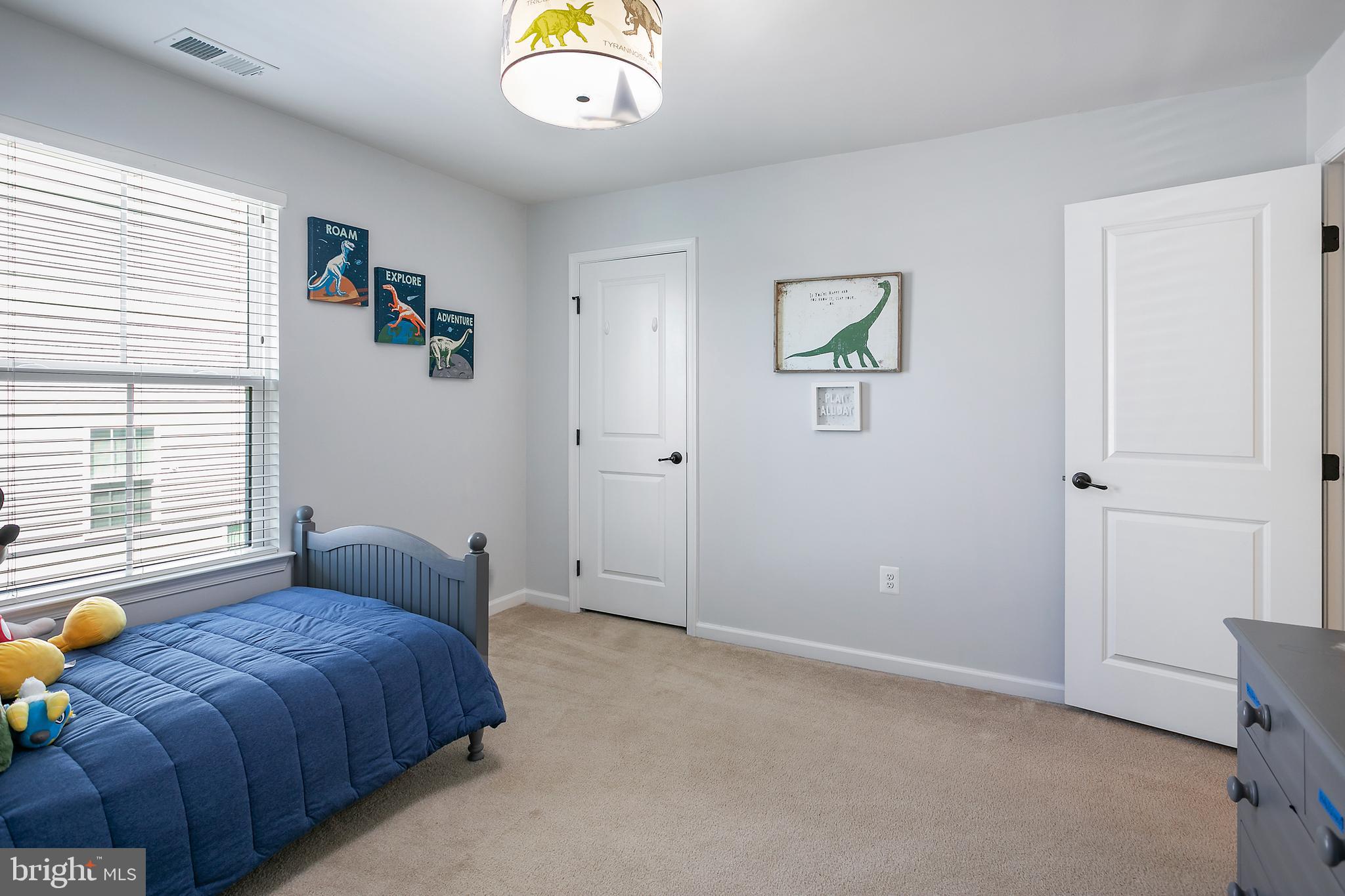 10576 Long Leaf Lane Waldorf, MD 20603 - Photo 29 of 54 a bedroom with a bed and a chandelier