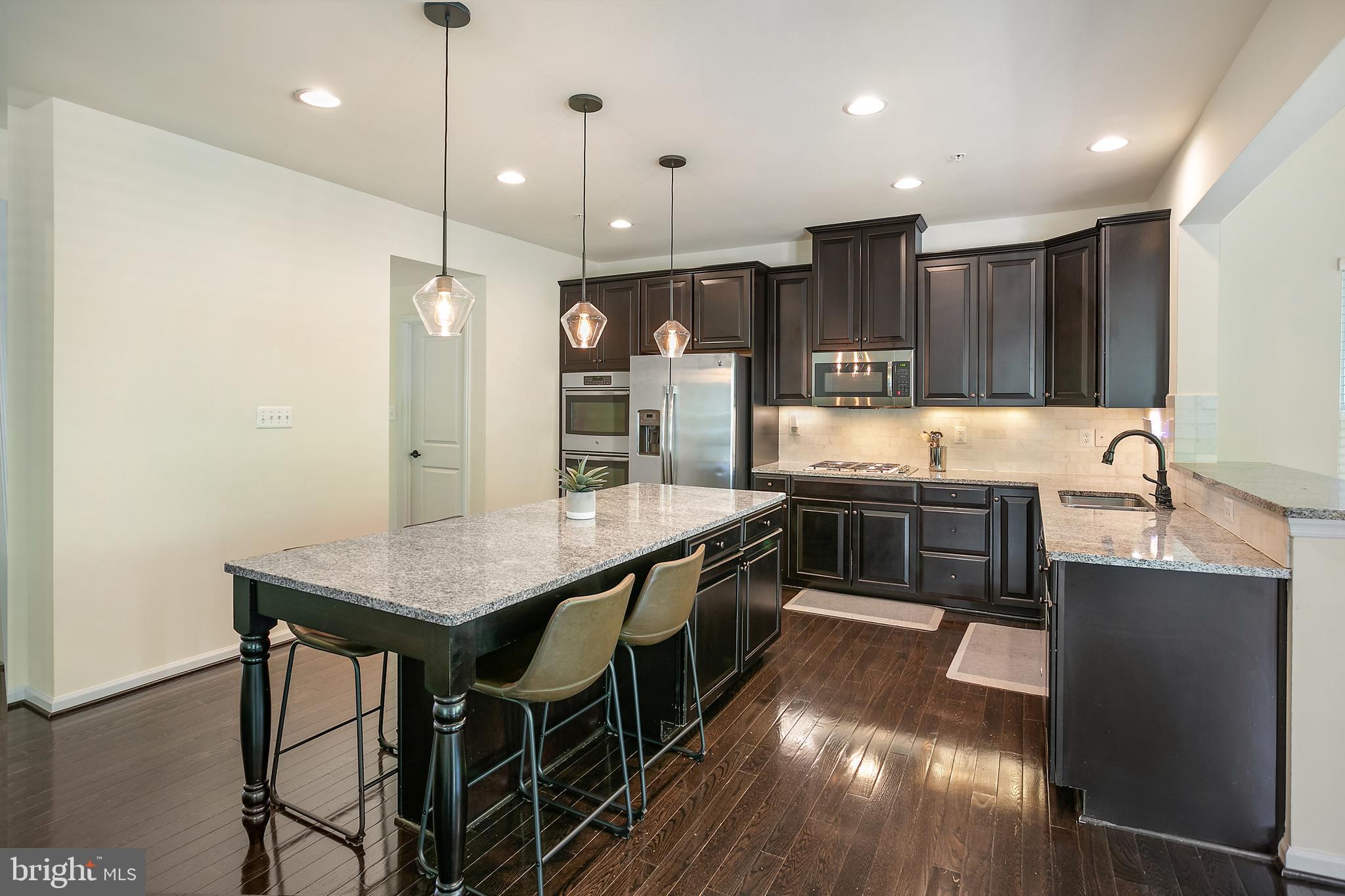10576 Long Leaf Lane Waldorf, MD 20603 - Photo 3 of 54 a large kitchen with a table and chairs in it