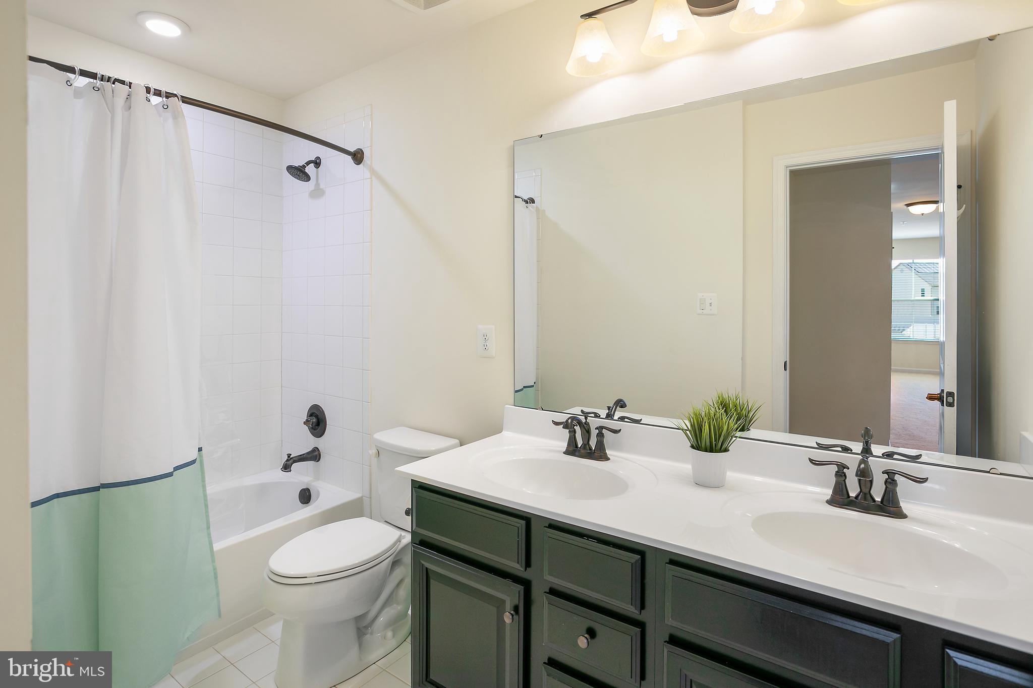 10576 Long Leaf Lane Waldorf, MD 20603 - Photo 33 of 54 a bathroom with a sink a toilet and shower