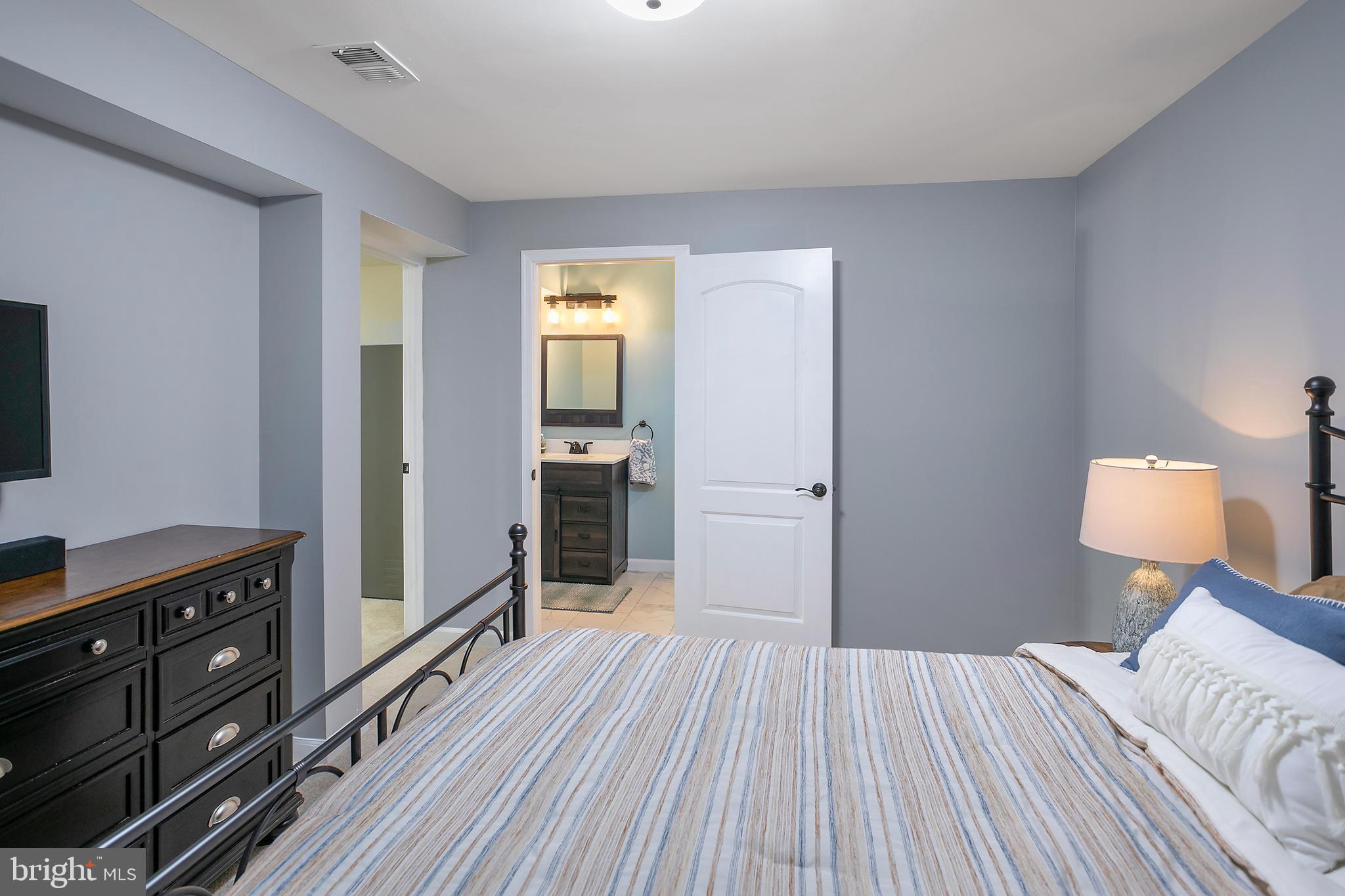 10576 Long Leaf Lane Waldorf, MD 20603 - Photo 36 of 54 a bedroom with a bed and a dresser