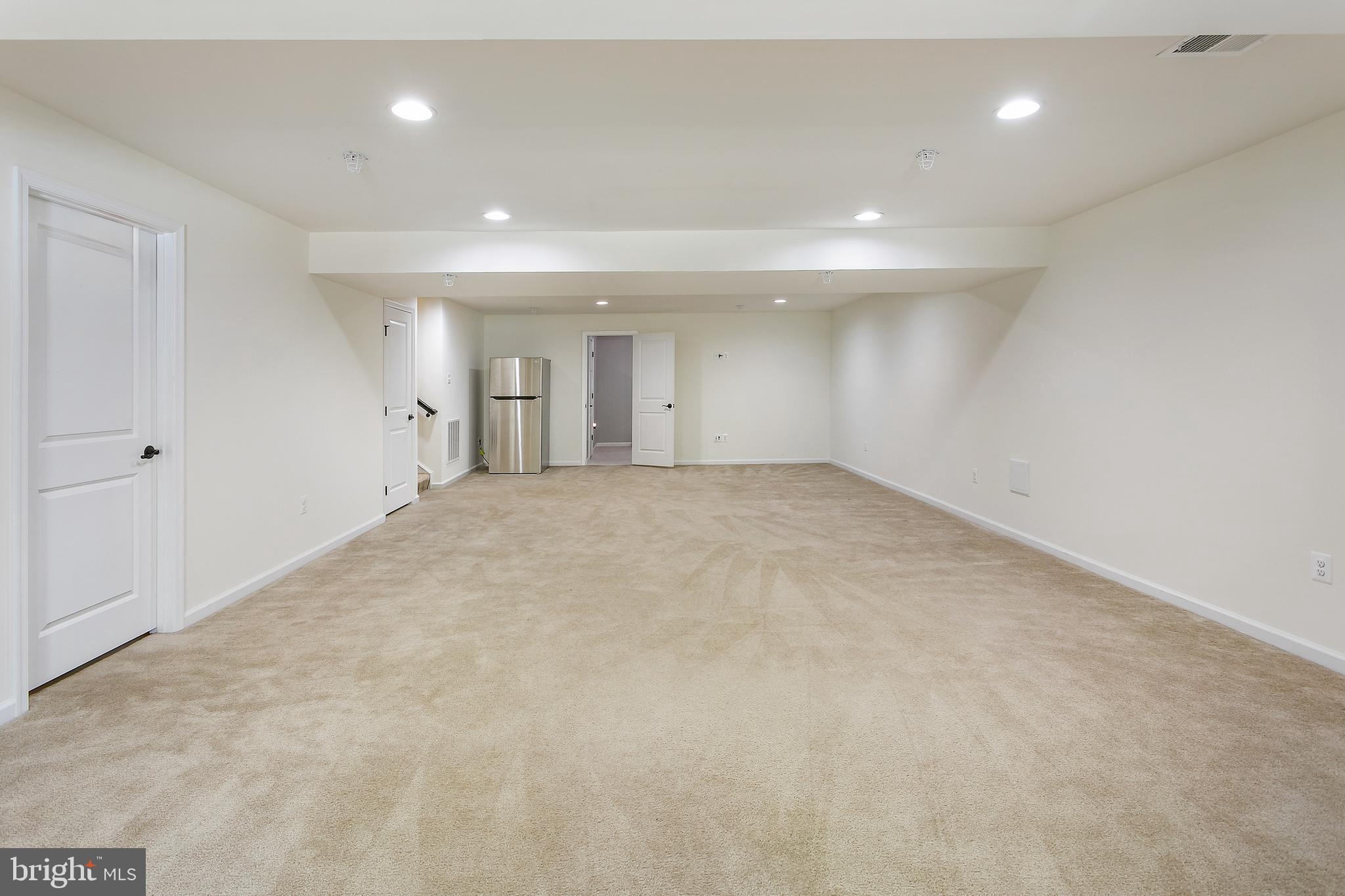 10576 Long Leaf Lane Waldorf, MD 20603 - Photo 39 of 54 an empty room with windows and entrance to other room
