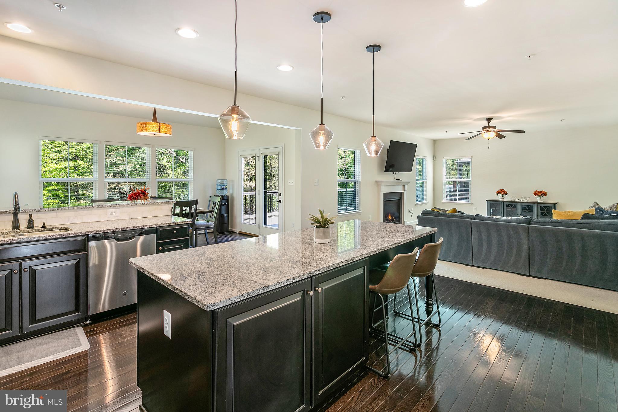 10576 Long Leaf Lane Waldorf, MD 20603 - Photo 4 of 54 a kitchen with a kitchen island sink and wooden floor