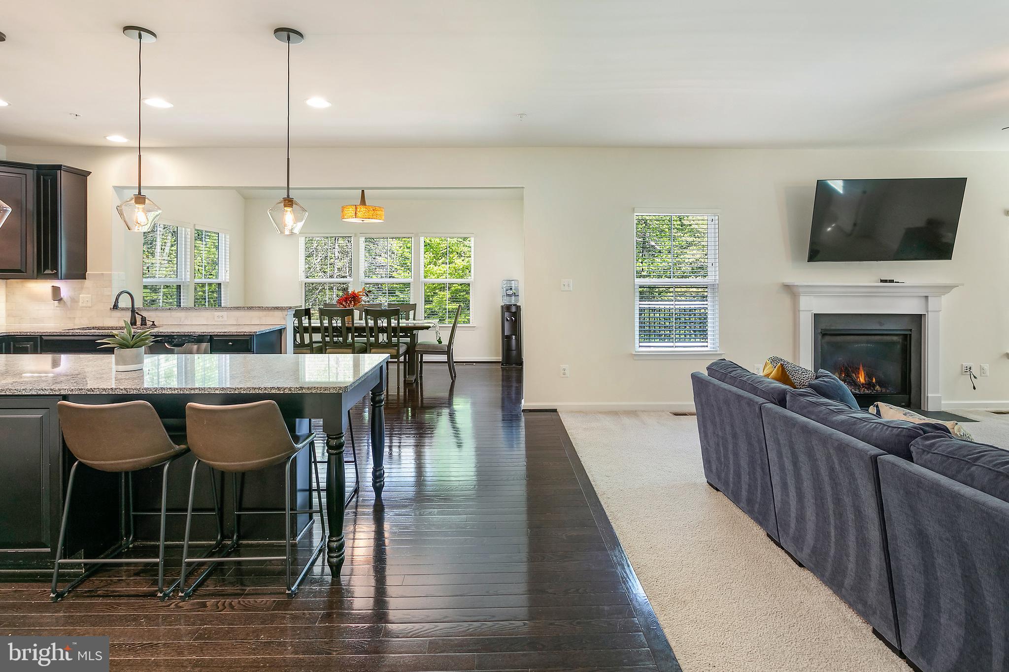 10576 Long Leaf Lane Waldorf, MD 20603 - Photo 5 of 54 a kitchen with granite countertop a stove a sink a dining table and chairs