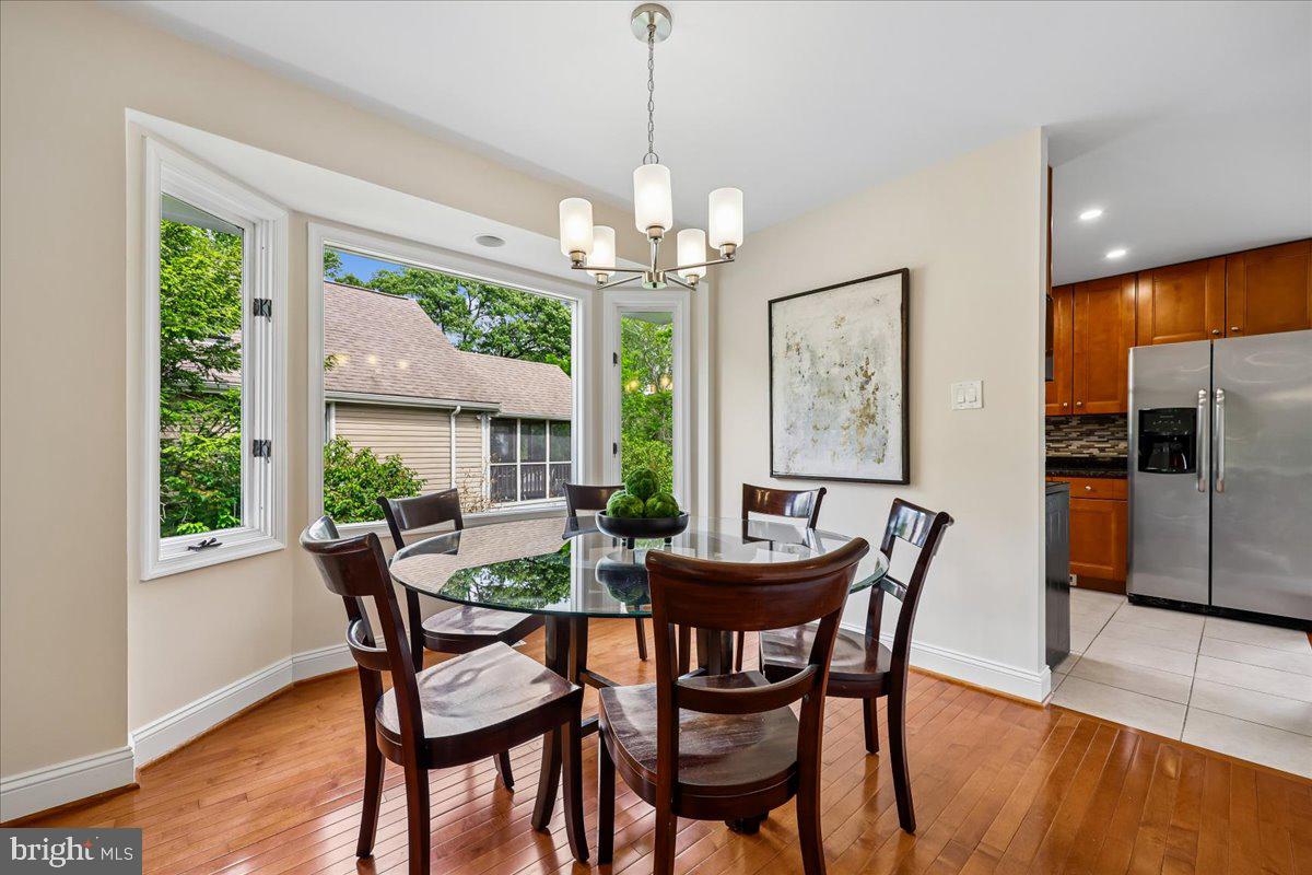 10029 Pratt Place Silver Spring, MD 20910 - Photo 14 of 36 a dining room with furniture a chandelier and wooden floor