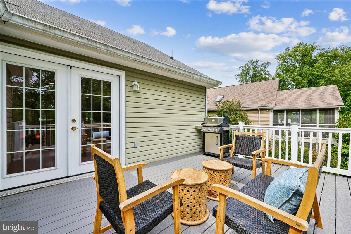 10029 Pratt Place Silver Spring, MD 20910 - Photo 20 of 36 a view of a patio with table and chairs with wooden floor and fence
