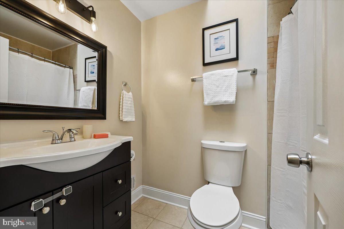 10029 Pratt Place Silver Spring, MD 20910 - Photo 23 of 36 a bathroom with a toilet a sink and mirror