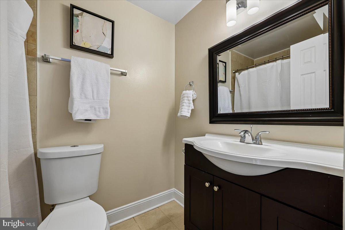 10029 Pratt Place Silver Spring, MD 20910 - Photo 28 of 36 a bathroom with a toilet sink and mirror