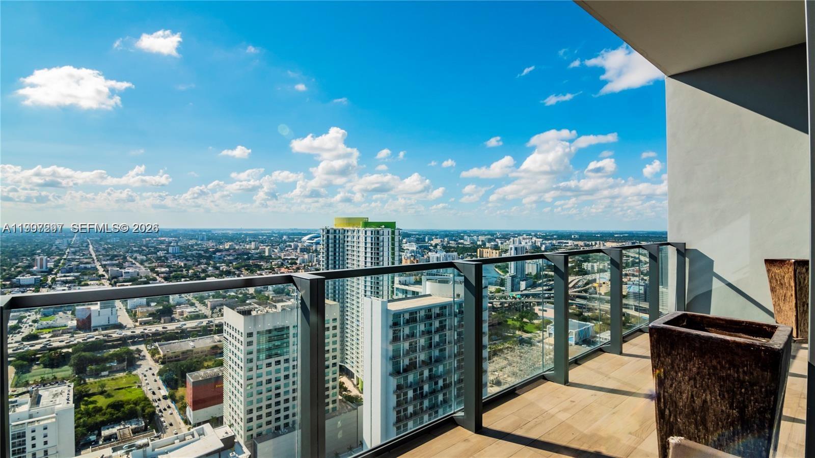88 Southwest 7th Street, Unit 4106 Miami, FL 33130 - Photo 18 of 21 a view of a balcony with an outdoor seating