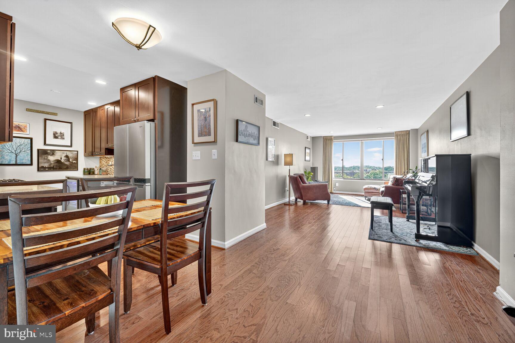 a living room with furniture a counter space and a refrigerator