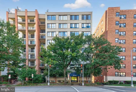 a view of a tall building next to a road