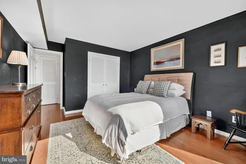 a bedroom with a bed and a couch