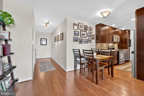 a view of a dining room with furniture and wooden floor