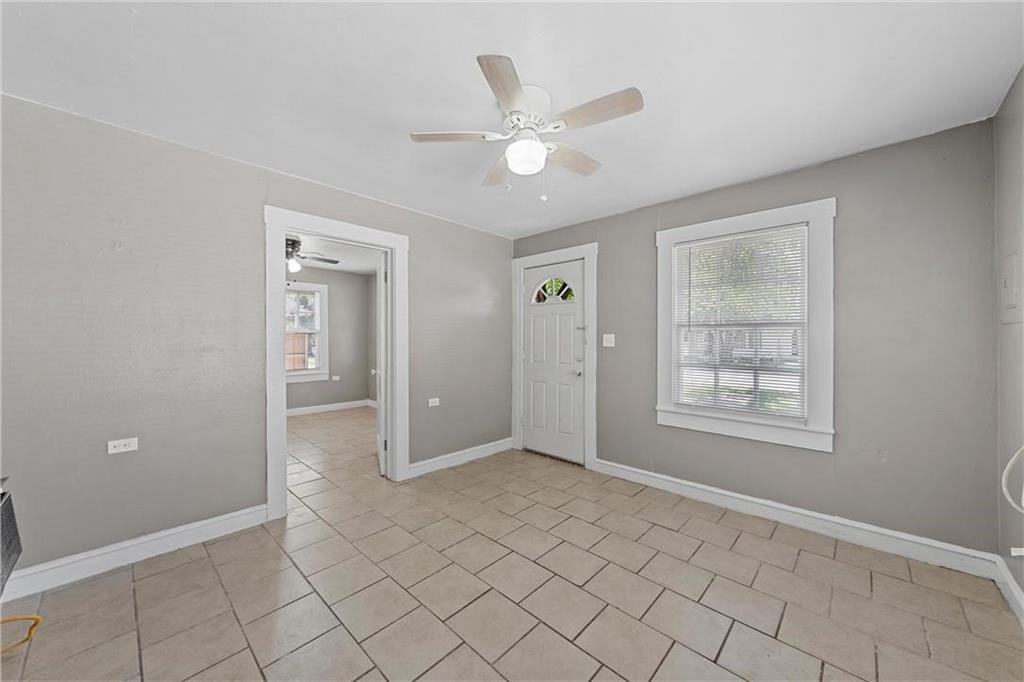 1121 Ashleman Street Waco, TX 76705 - Photo 4 of 11 a view of an empty room with window and chandelier fan