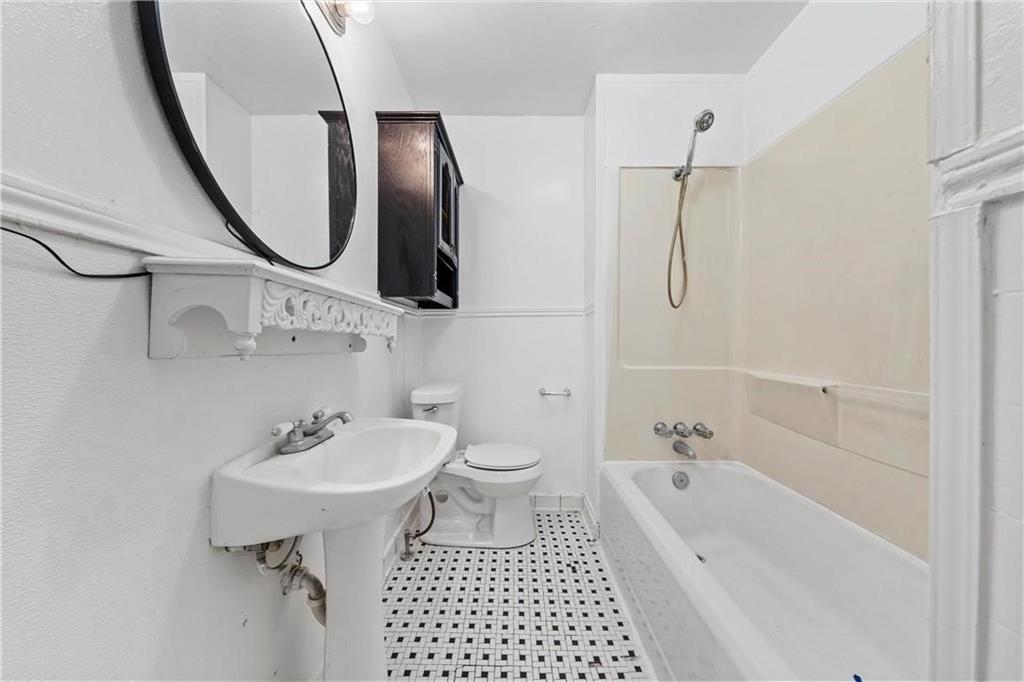 1121 Ashleman Street Waco, TX 76705 - Photo 9 of 11 a bathroom with a sink a toilet and a mirror