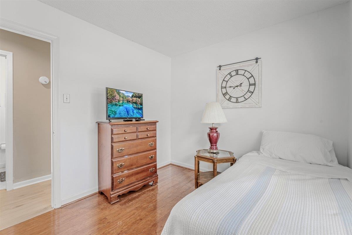 2976 Kin Cove, Unit 2976 Memphis, TN 38119 - Photo 14 of 24 Bright room featuring wood-finish flooring, white painted walls, and a white ceiling