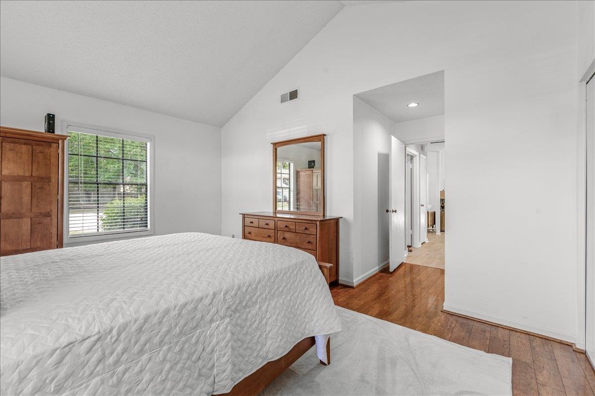 2976 Kin Cove, Unit 2976 Memphis, TN 38119 - Photo 17 of 24 Spacious interior featuring a vaulted ceiling, wood-finish flooring, and a large window with blinds