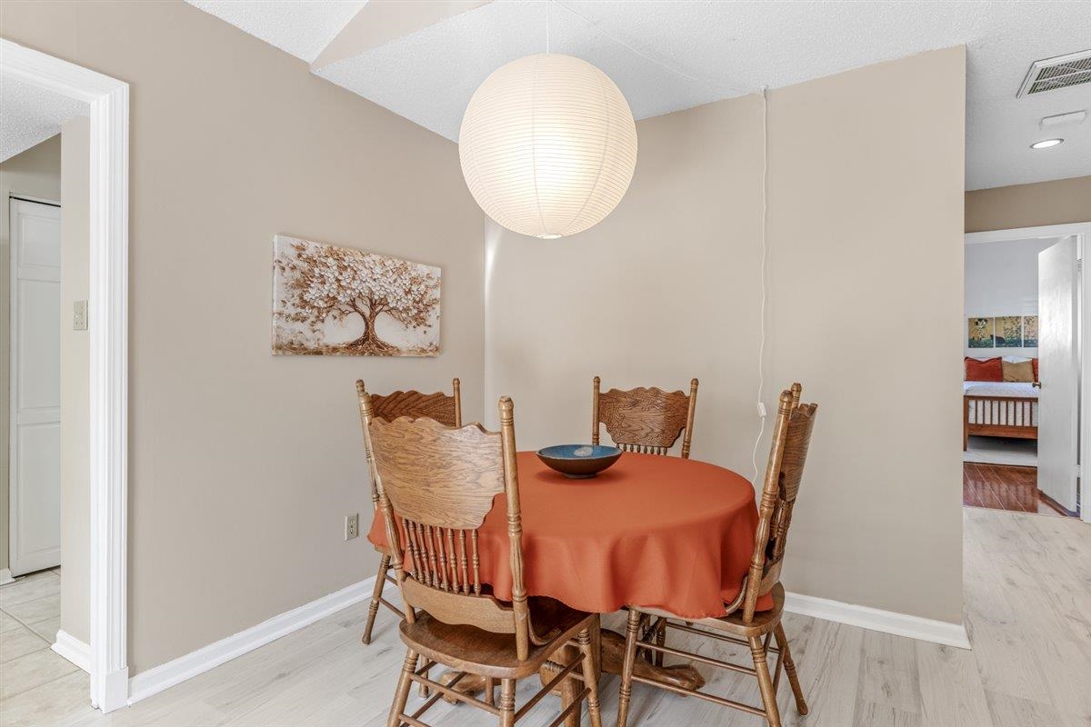 2976 Kin Cove, Unit 2976 Memphis, TN 38119 - Photo 7 of 24 Dining area featuring a paper globe pendant light fixture, light wood-finish flooring, and neutral wall tones