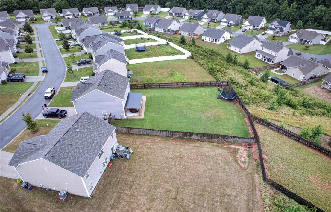 213 Millhone Way Pendleton, SC 29670 - Photo 22 of 25 An aerial perspective reveals a vibrant neighborhood with well-maintained homes and private fenced yards.