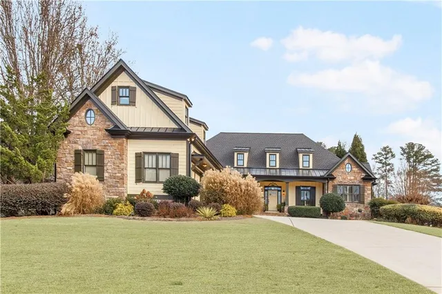 a front view of a house with a yard and garage