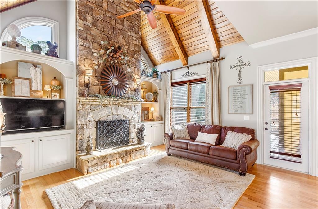 154 Gold Leaf Trail Powder Springs, GA 30127 - Photo 23 of 61 a living room with furniture a flat screen tv and a fireplace