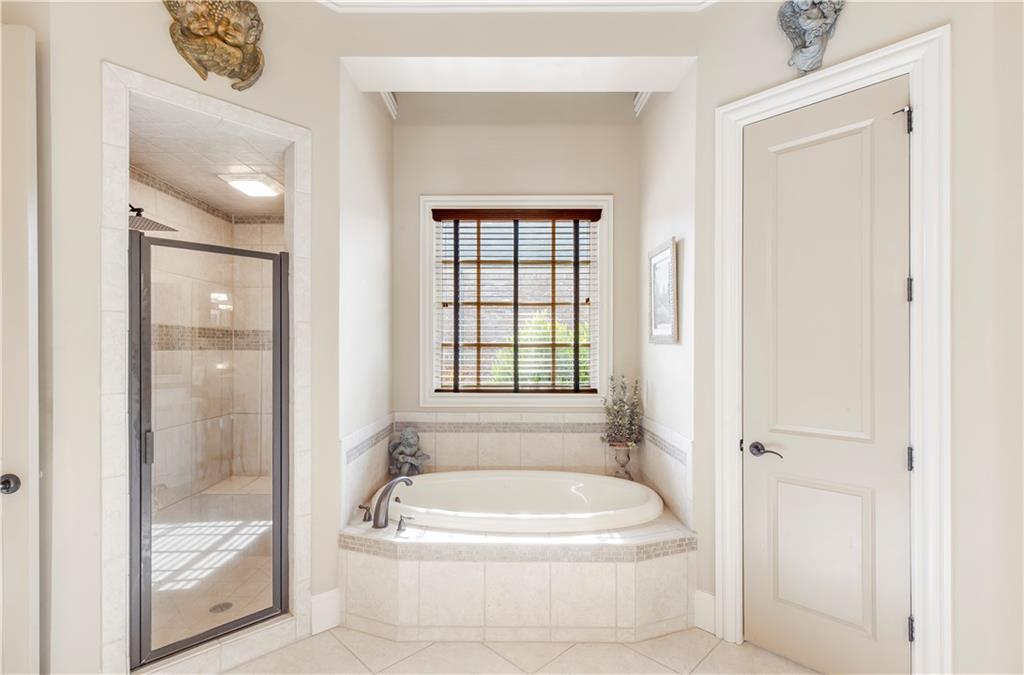 154 Gold Leaf Trail Powder Springs, GA 30127 - Photo 31 of 61 a white bath tub sitting next to a white toilet