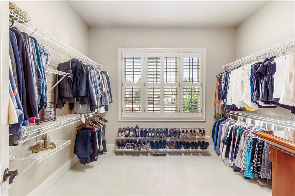 154 Gold Leaf Trail Powder Springs, GA 30127 - Photo 32 of 61 a view of walk in closet with clothes and shoes