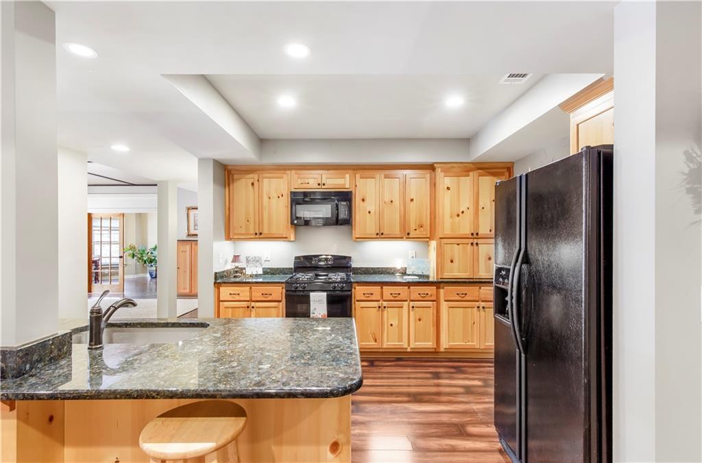 154 Gold Leaf Trail Powder Springs, GA 30127 - Photo 42 of 61 a kitchen with stainless steel appliances granite countertop a sink stove and refrigerator