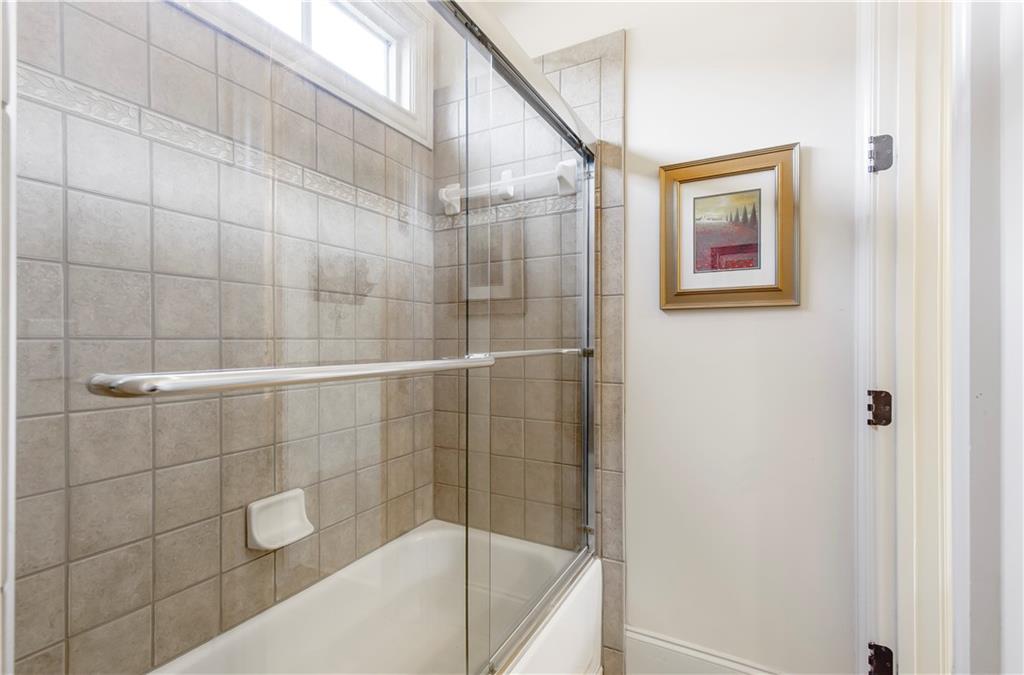 154 Gold Leaf Trail Powder Springs, GA 30127 - Photo 50 of 61 a bathroom with a bathtub and shower