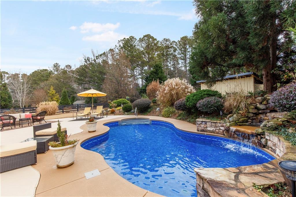 154 Gold Leaf Trail Powder Springs, GA 30127 - Photo 5 of 61 a view of a swimming pool with outdoor seating