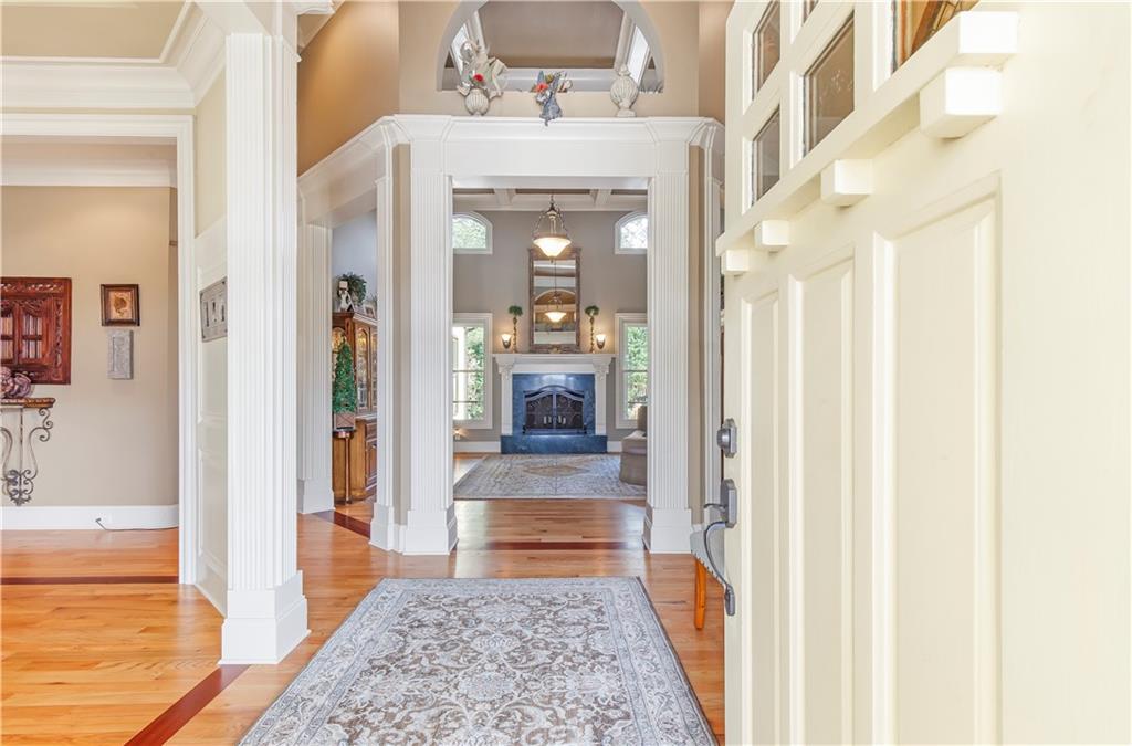 154 Gold Leaf Trail Powder Springs, GA 30127 - Photo 6 of 61 a view of a hallway with wooden floor and a living room